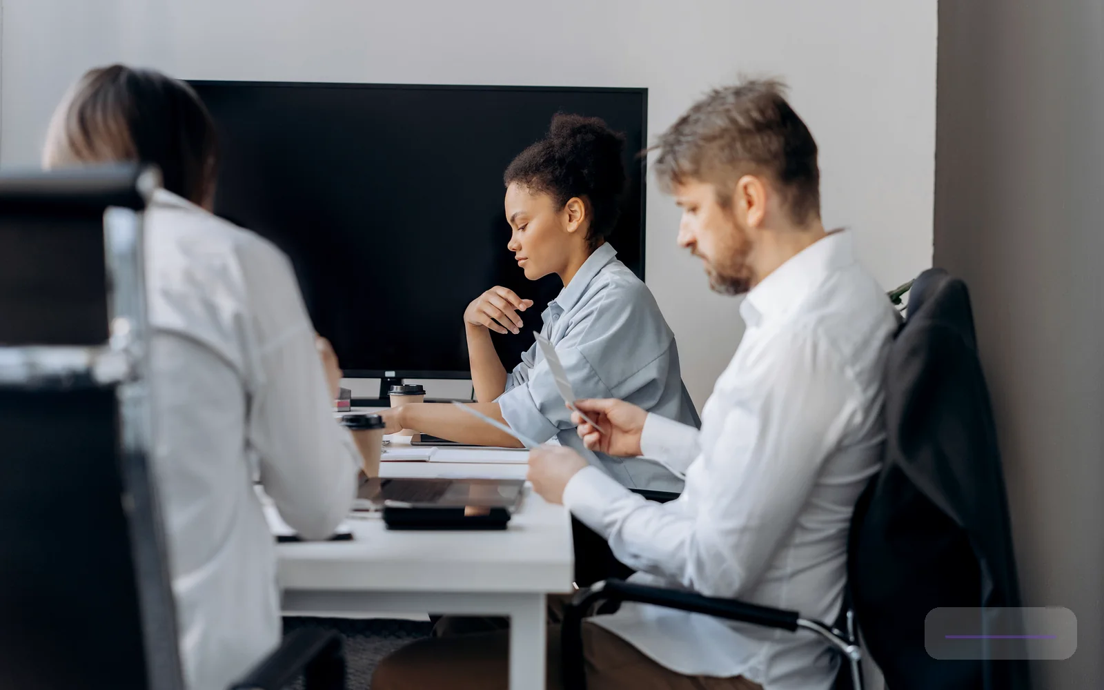 A professional conference planning discussion with attendees in a modern event environment